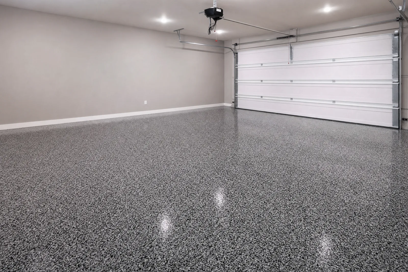 The same garage finished in a grey and black full-broadcast flake epoxy floor
