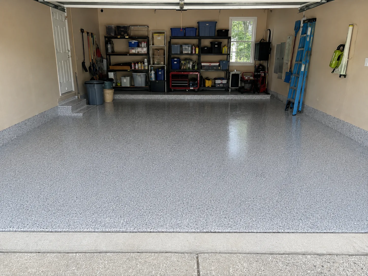 The same garage after a full-broadcast flake epoxy floor with a clear topcoat