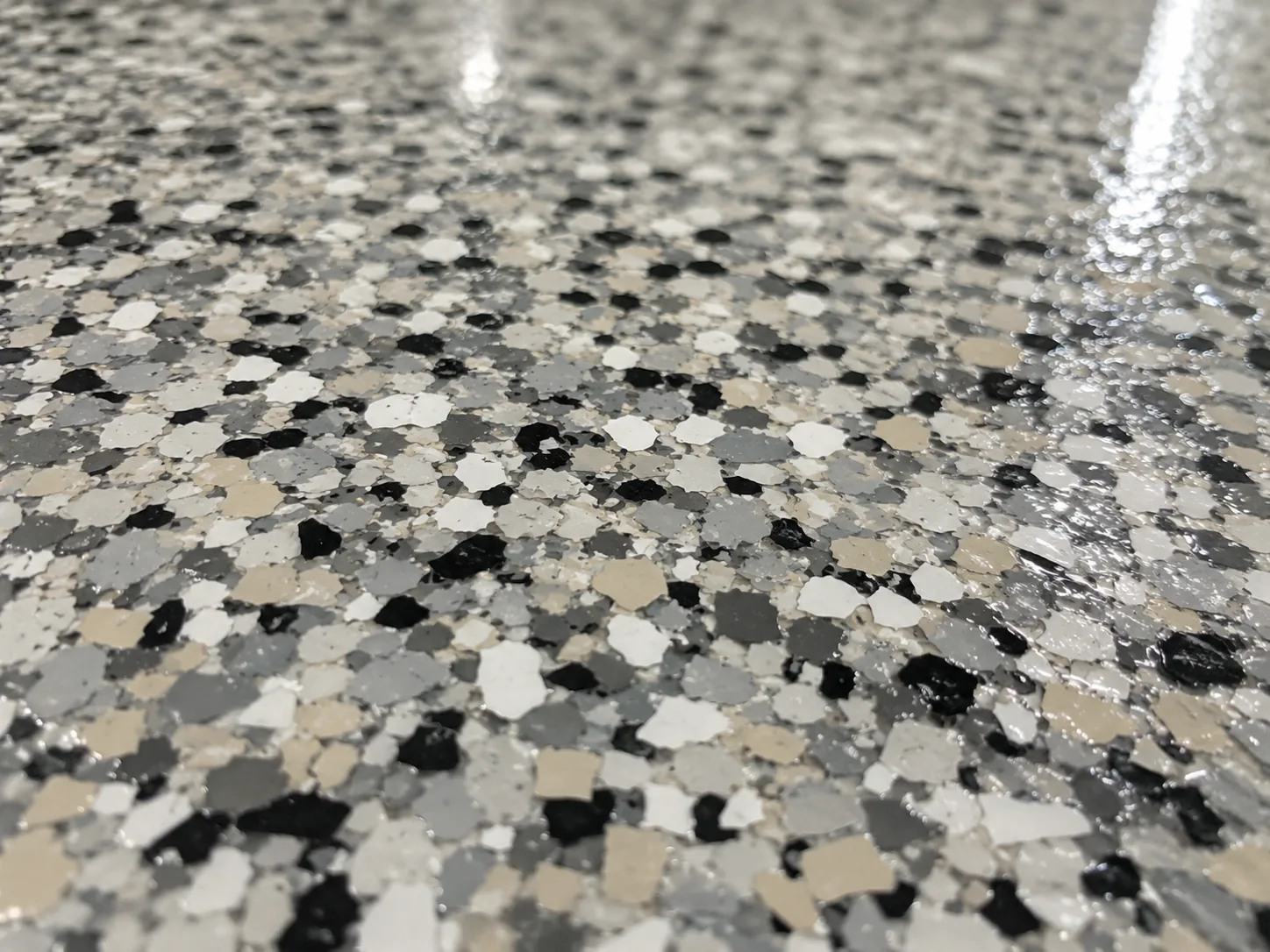 Macro view of a textured broadcast coating surface under a clear topcoat