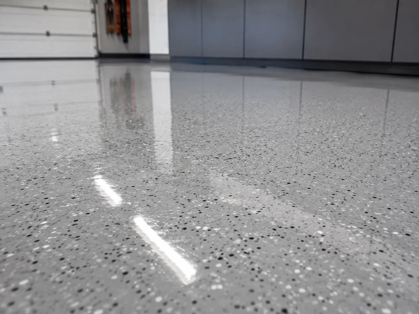 Low angle view across a high gloss black and silver flake epoxy floor